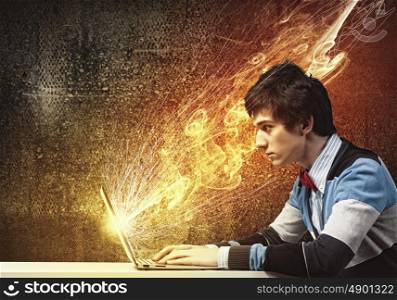 Businessman using laptop. Image of young businessman at work using laptop