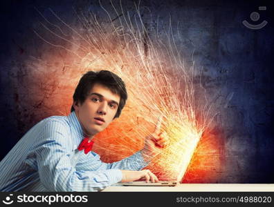 Businessman using laptop. Image of young businessman at work using laptop