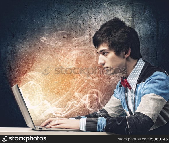 Businessman using laptop. Image of young businessman at work using laptop