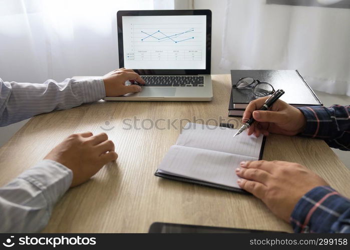 Businessman using laptop to teach and analysis the situation on the market value , Business concept