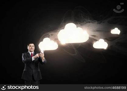 Businessman using mobile application. Businessman using his smartphone and cloud computing concept