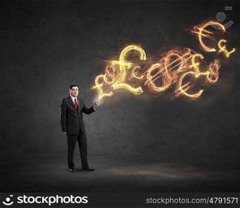 Businessman using mobile application. Businessman using his smartphone and glowing currency signs coming of screen