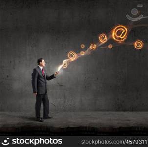 Businessman using mobile application. Businessman using his smartphone and glowing email sign of screen