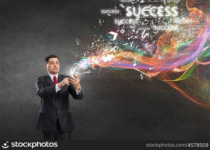 Businessman using mobile application. Businessman using his smartphone and glowing light out of screen