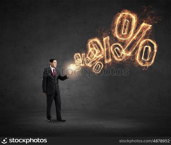 Businessman using mobile application. Businessman using his smartphone and glowing percent sign of screen