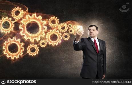 Businessman using mobile application. Businessman using his smartphone and glowing settings icons of screen