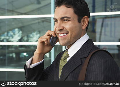 Businessman using mobile phone outdoors