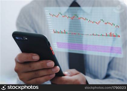 businessman using mobile phone to analyze stock market and economic growth chart with icons on a virtual screen. business strategy Finance and Banking digital marketing