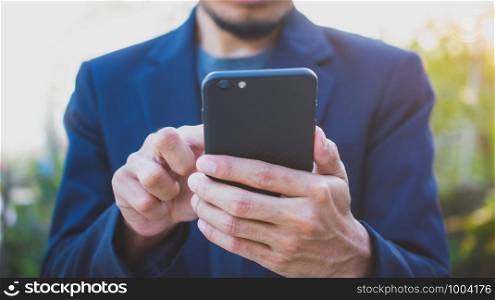 Businessman using mobile smart phone looking on screen connection online media technology