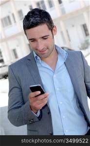 Businessman using mobilephone out in town