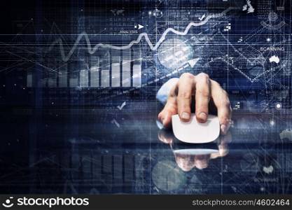 Businessman using mouse. Hand of businessman in suit on dark background using wireless computer mouse