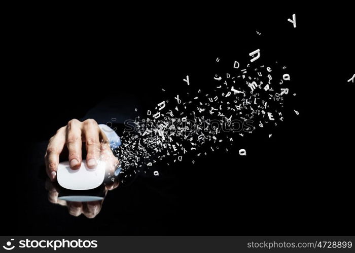 Businessman using mouse. Hand of businessman in suit on dark background using wireless computer mouse