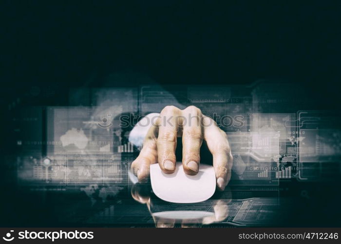 Businessman using mouse. Hand of businessman in suit on dark digital background using wireless computer mouse