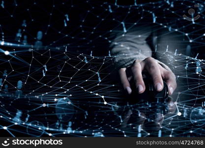 Businessman using mouse. Hand of businessman in suit on dark digital background using wireless computer mouse