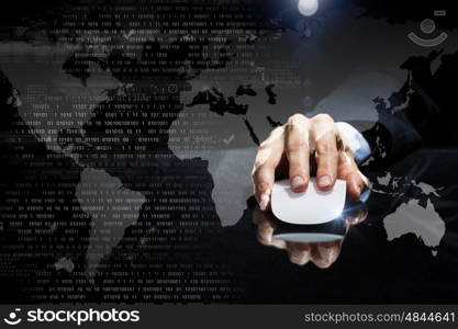 Businessman using mouse. Hand of businessman in suit on dark digital background using wireless computer mouse