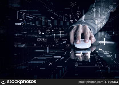 Businessman using mouse. Hand of businessman in suit on dark digital background using wireless computer mouse