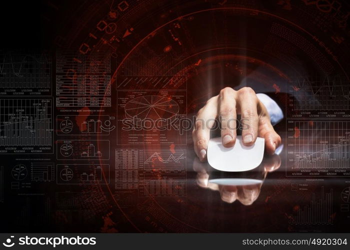 Businessman using mouse. Hand of businessman in suit on dark digital background using wireless computer mouse