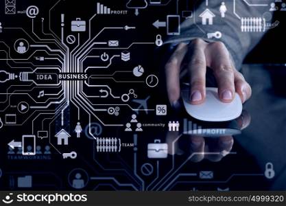 Businessman using mouse. Hand of businessman in suit on dark digital background using wireless computer mouse