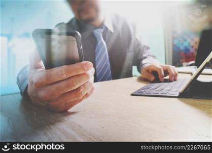 businessman using smart phone and keyboard dock digital tablet.Worldwide network connection technology interface.on marble desk,sun flare effect