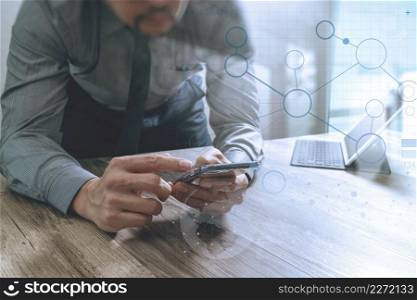 businessman using smart phone and keyboard dock digital tablet.Worldwide network connection technology interface.on wooden desk,sun flare effect
