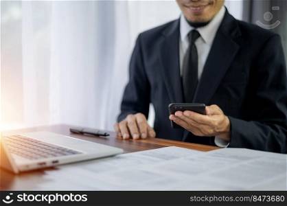 Businessman using smartphone mobile technology in office