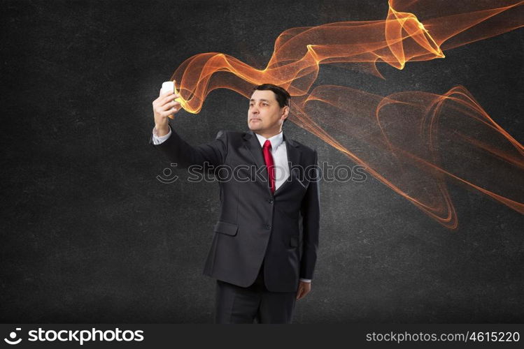 Businessman using smartphone. Senior businessman using his smartphone for business and communication