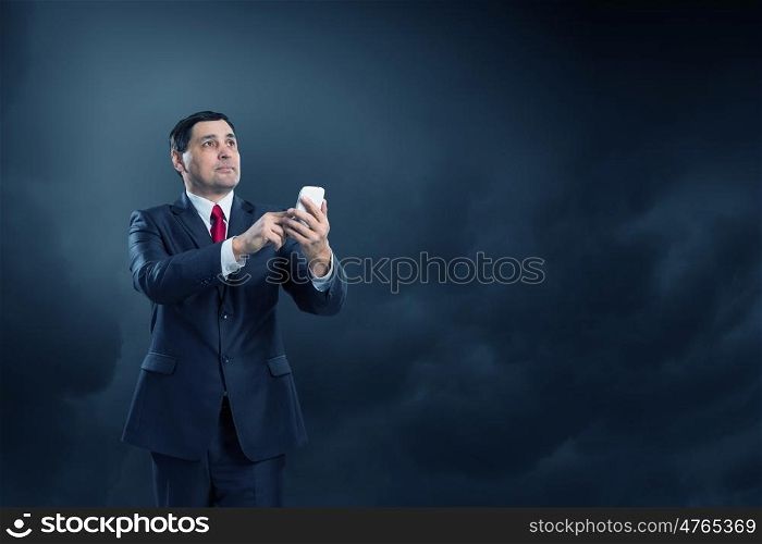 Businessman using smartphone. Senior businessman using his smartphone for business and communication