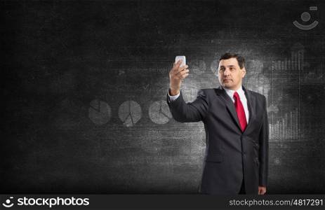 Businessman using smartphone. Senior businessman using his smartphone for business and communication