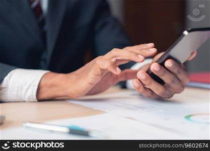 Businessman using smartphone to checking report while analysis financial and accounting of project.