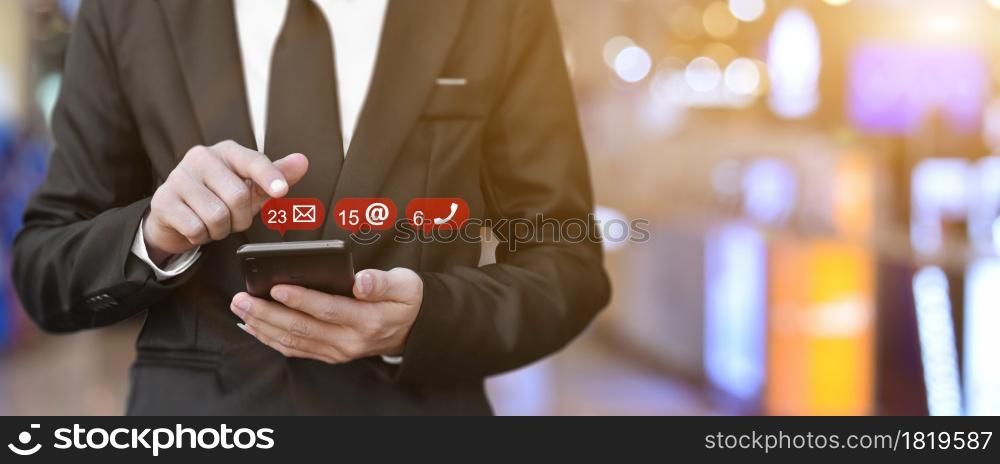 Businessman using smartphone with contact us icon, Copy space. Idea for business, online banking, technology, send sms.