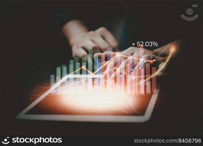 Businessman using tablet analyzing sales data and economic growth graph chart. Business strategy, financial and banking. Digital marketing.