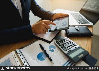  Businessman using tablet to the situation on the market value , Business concept.