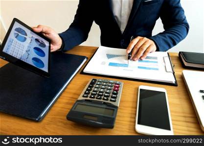 Businessman using tablet to the situation on the market value , Business concept.