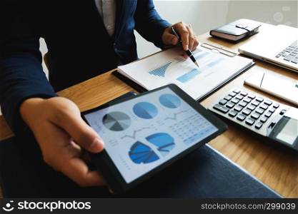 Businessman using tablet to the situation on the market value , Business concept.