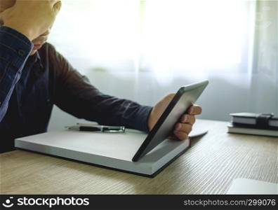 Businessman using tablet to the situation on the market value , Business concept