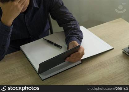 Businessman using tablet to the situation on the market value , Business concept