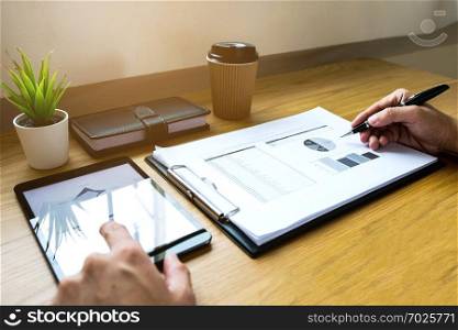  Businessman using tablet to the situation on the market value , Business concept.
