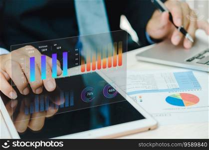 Businessman using tablet with statistics, graph and chart virtual hologram of statistics.Data analytics and statistics. business marketing investment and financial concept.