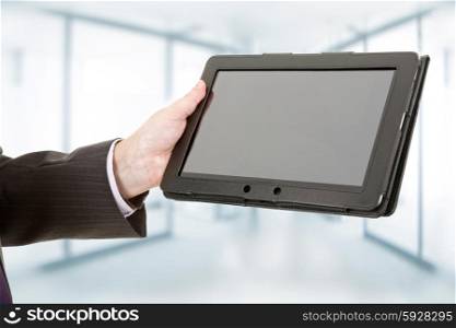 businessman using touch pad, close up shot on tablet pc, at the office