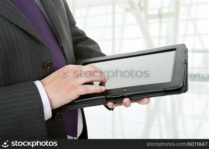 businessman using touch pad, close up shot on tablet pc, at the office