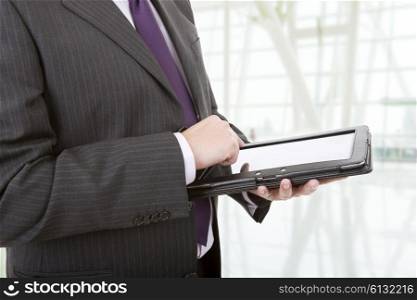 businessman using touch pad, close up shot on tablet pc at the office