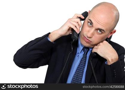 Businessman using two phones