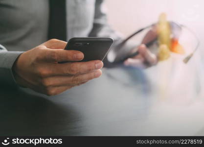 businessman using VOIP headset with mobile phone and concept communication call center on wooden desk