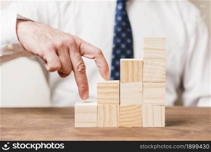 businessman using wooden pieces. Resolution and high quality beautiful photo. businessman using wooden pieces. High quality beautiful photo concept