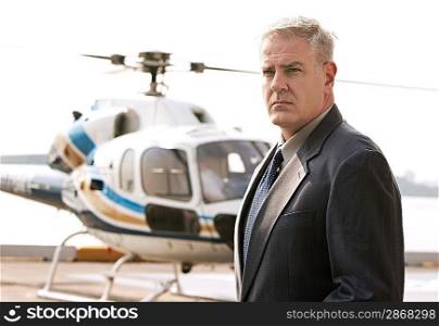 Businessman waiting at helicopter pad