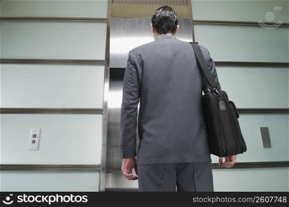 Businessman waiting for elevator
