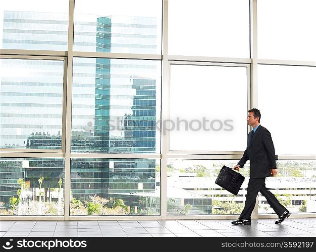 Businessman walking by office window