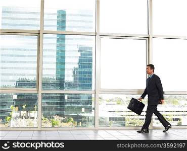 Businessman walking by office window