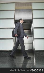 Businessman walking in a corridor