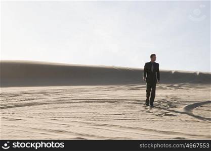 Businessman walking in desert